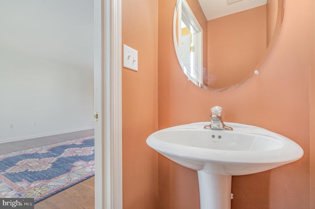 bathroom featuring wood finished floors and baseboards