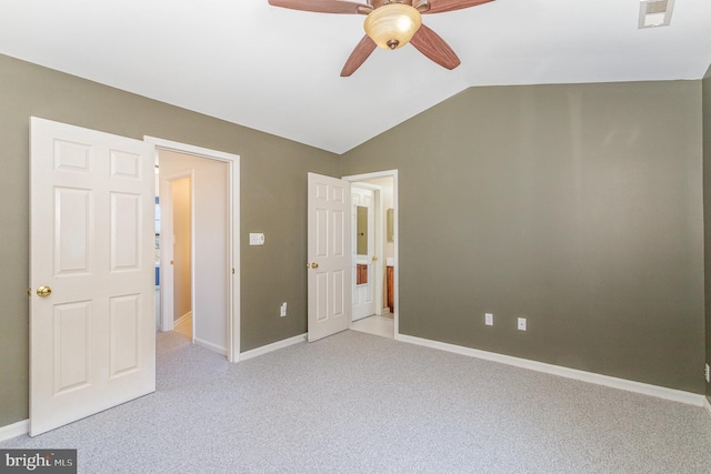 unfurnished bedroom featuring visible vents, ceiling fan, baseboards, carpet, and lofted ceiling