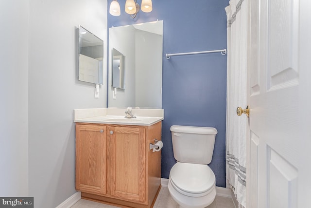 bathroom featuring tile patterned floors, toilet, vanity, and baseboards