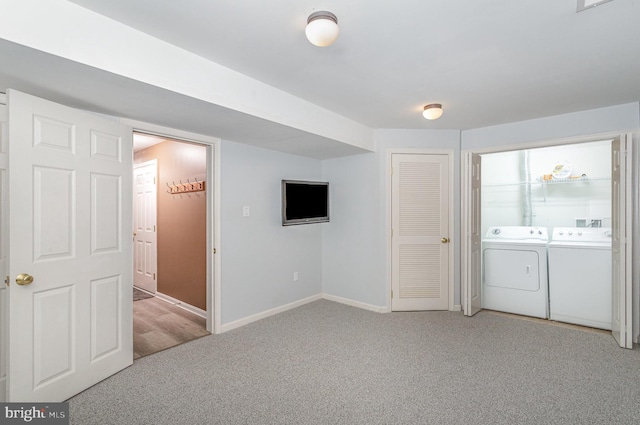 interior space with washer and dryer, baseboards, and carpet flooring