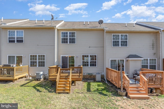 back of house featuring a deck, cooling unit, and a yard