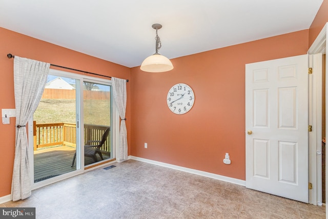 unfurnished room with visible vents and baseboards