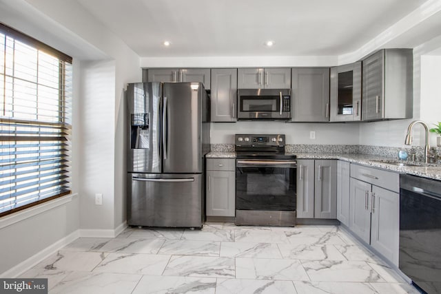 kitchen featuring a sink, gray cabinetry, a healthy amount of sunlight, and stainless steel appliances