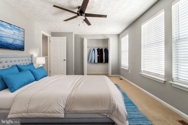 bedroom with visible vents, baseboards, carpet, and a closet