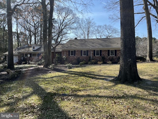 view of front of house with brick siding and a front yard