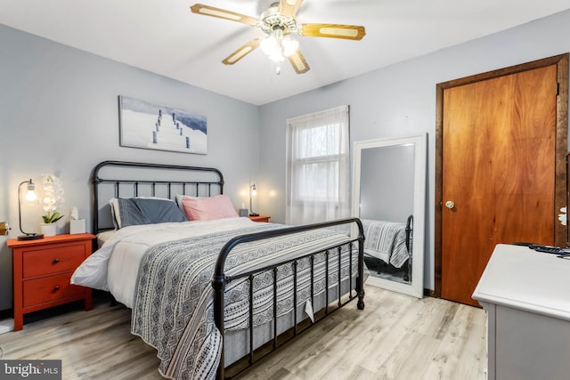 bedroom featuring a ceiling fan and light wood finished floors