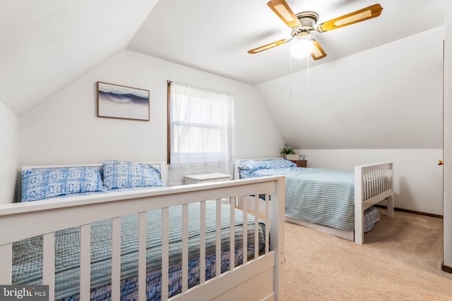 carpeted bedroom featuring ceiling fan and vaulted ceiling