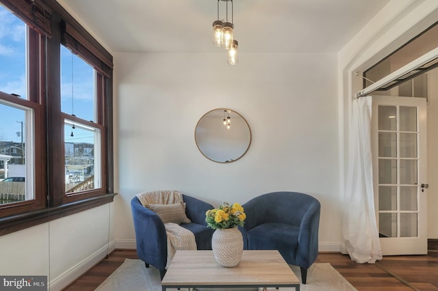 sitting room featuring baseboards and wood finished floors