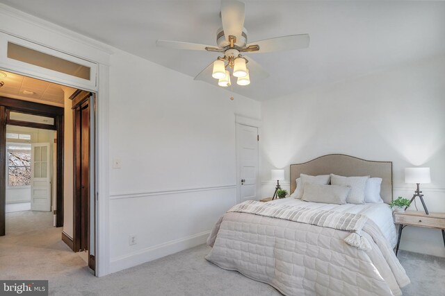 bedroom with a ceiling fan, baseboards, and carpet floors