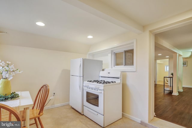 kitchen with white appliances, beamed ceiling, recessed lighting, and baseboards