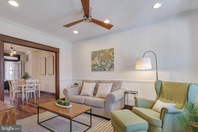 living area with crown molding, recessed lighting, wood finished floors, and ceiling fan