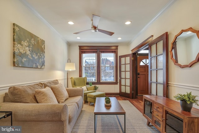 living area featuring a ceiling fan, crown molding, recessed lighting, and wood finished floors