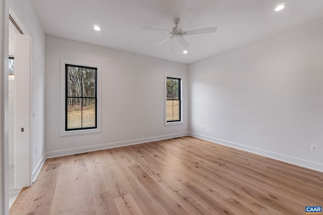 spare room with recessed lighting, light wood-style flooring, baseboards, and ceiling fan