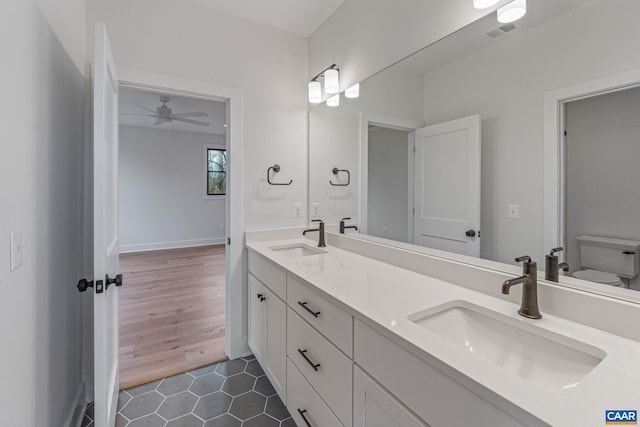 bathroom featuring a sink, visible vents, double vanity, and tile patterned flooring