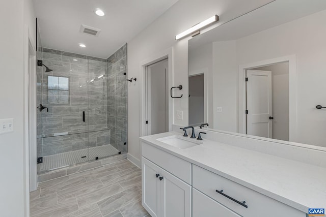 full bathroom with recessed lighting, visible vents, a stall shower, and vanity