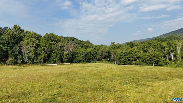 exterior space featuring a mountain view and a wooded view