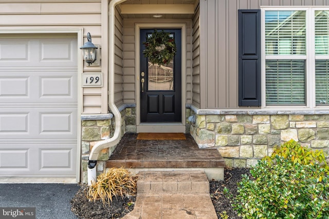 entrance to property featuring board and batten siding and stone siding