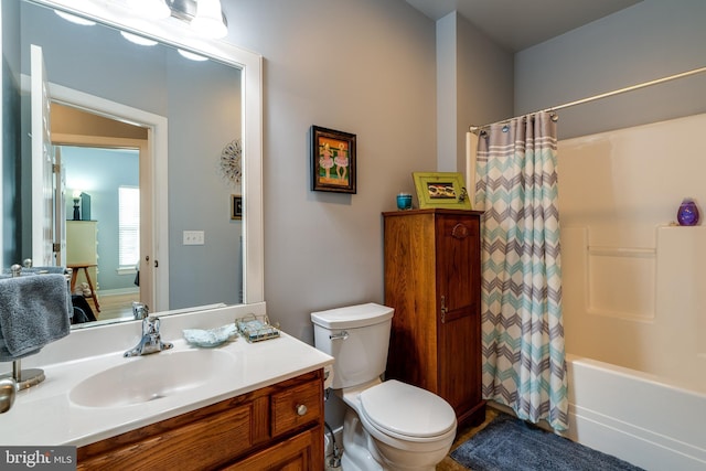 bathroom featuring shower / bathtub combination with curtain, toilet, and vanity