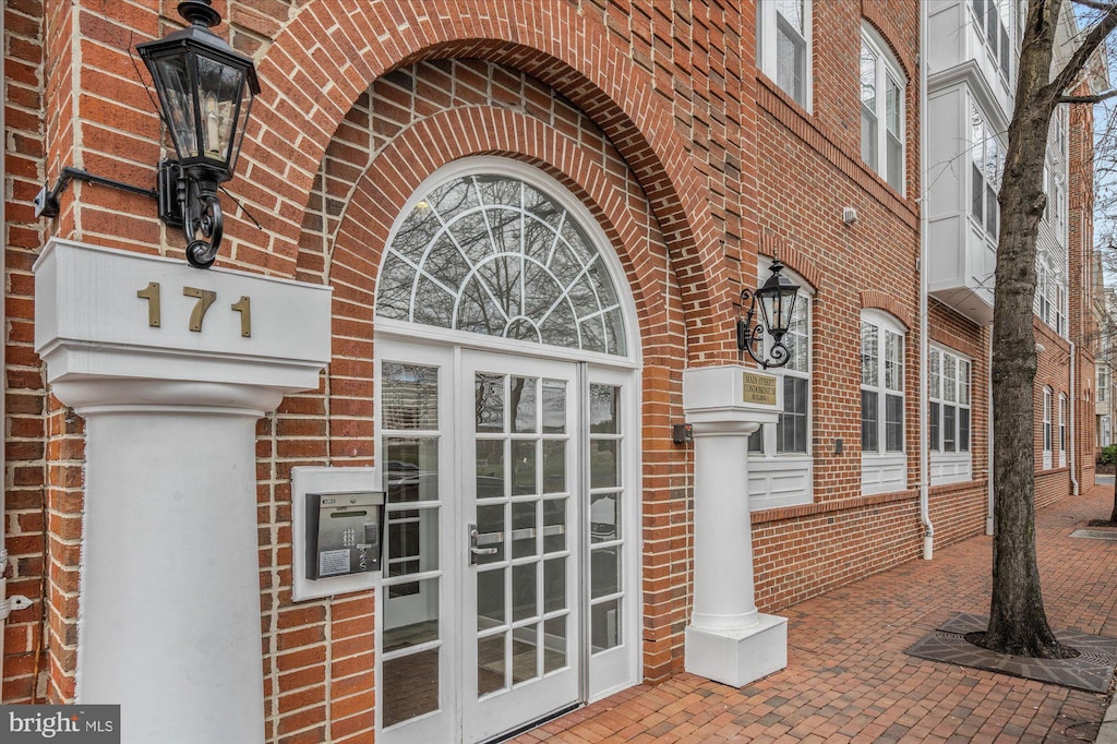 entrance to property with brick siding and french doors