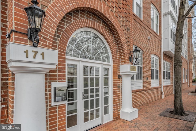 entrance to property with brick siding and french doors