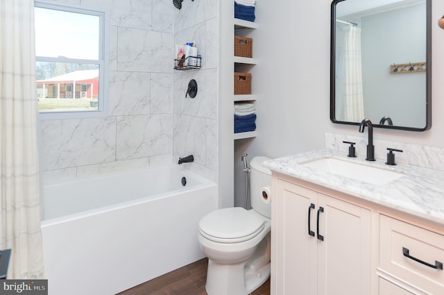 bathroom with vanity, toilet, wood finished floors, and shower / bath combo with shower curtain