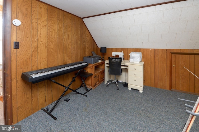 office space with vaulted ceiling, wooden walls, and carpet flooring