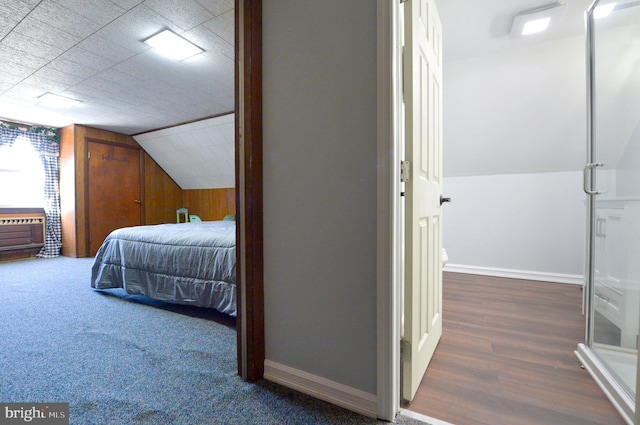 bedroom featuring lofted ceiling and baseboards