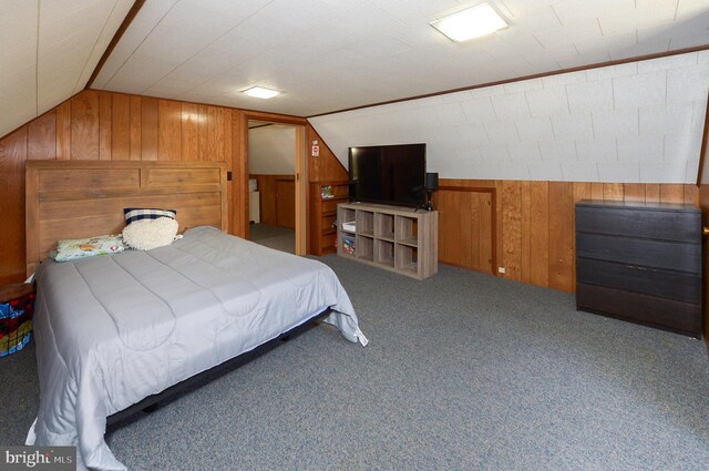 carpeted bedroom featuring vaulted ceiling and wood walls