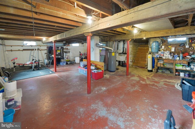 basement with stairway and a workshop area