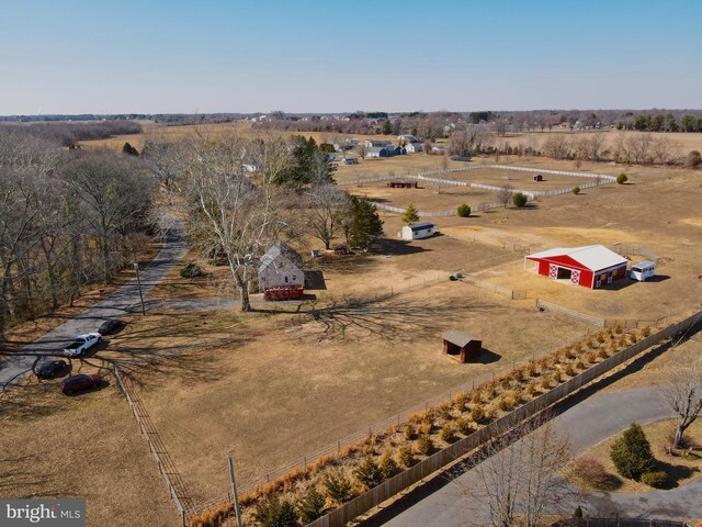 birds eye view of property with a rural view