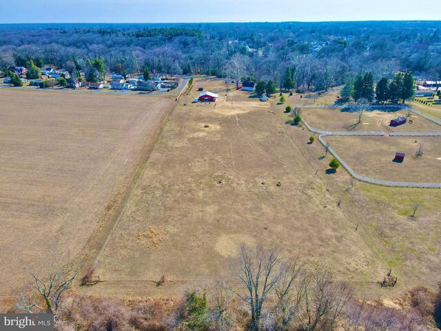 birds eye view of property with a rural view and a wooded view