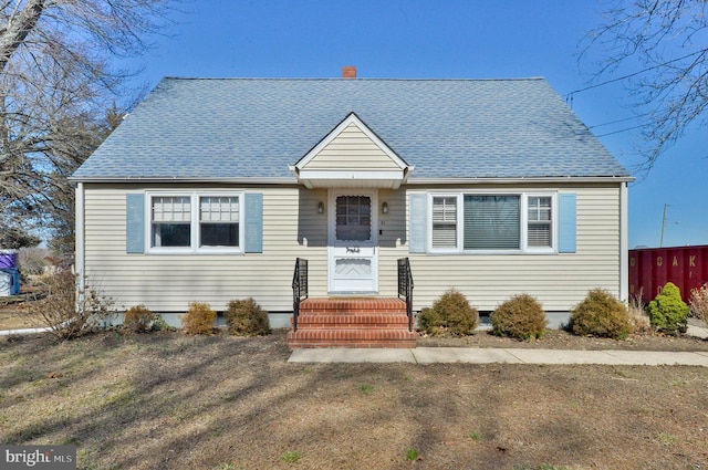 bungalow-style house featuring roof with shingles and fence