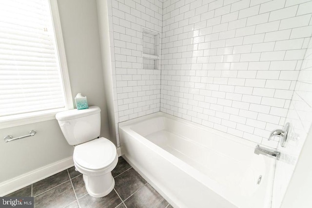 full bathroom with tile patterned flooring, tub / shower combination, toilet, and baseboards