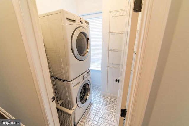 laundry room featuring stacked washer / drying machine and laundry area