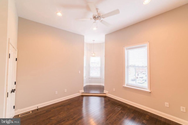 spare room featuring visible vents, dark wood-type flooring, recessed lighting, baseboards, and ceiling fan