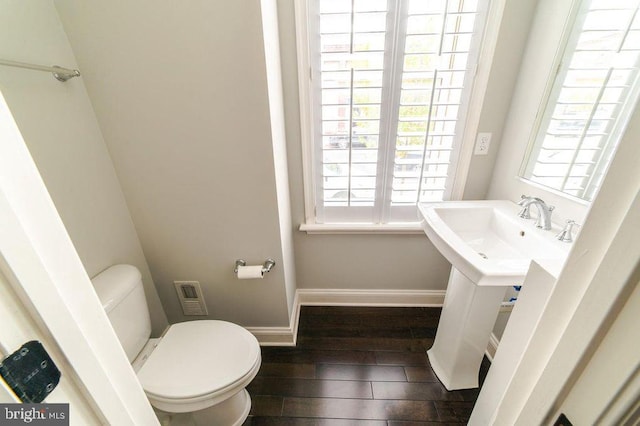 bathroom featuring visible vents, toilet, baseboards, and wood finished floors