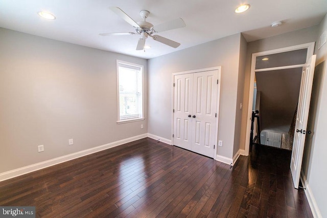 unfurnished bedroom featuring dark wood finished floors, recessed lighting, baseboards, and a closet