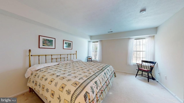 bedroom featuring visible vents, baseboards, and light carpet