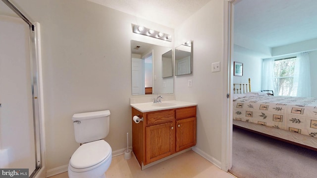 bathroom with connected bathroom, toilet, vanity, and baseboards