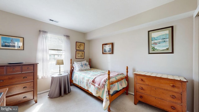 bedroom featuring visible vents and light carpet