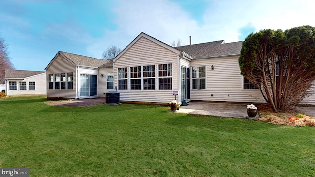 back of house featuring a patio area, a shingled roof, and a yard