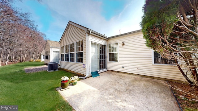 back of property featuring a yard, a patio, and central AC unit