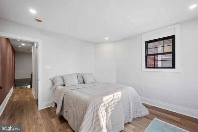 bedroom featuring recessed lighting, baseboards, and wood finished floors