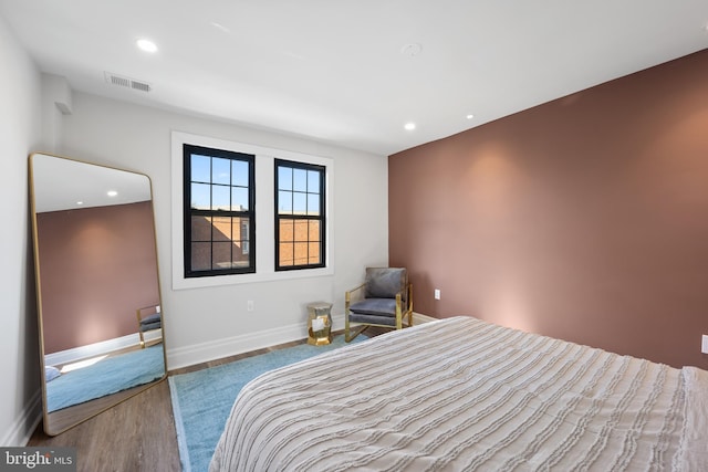 bedroom featuring recessed lighting, wood finished floors, visible vents, and baseboards