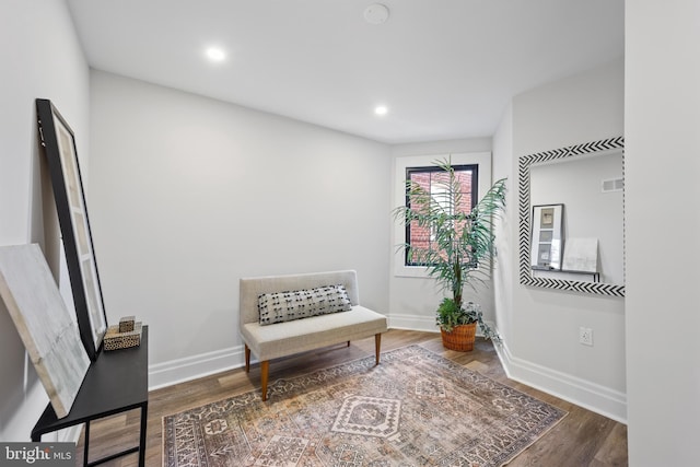 living area with recessed lighting, baseboards, and wood finished floors