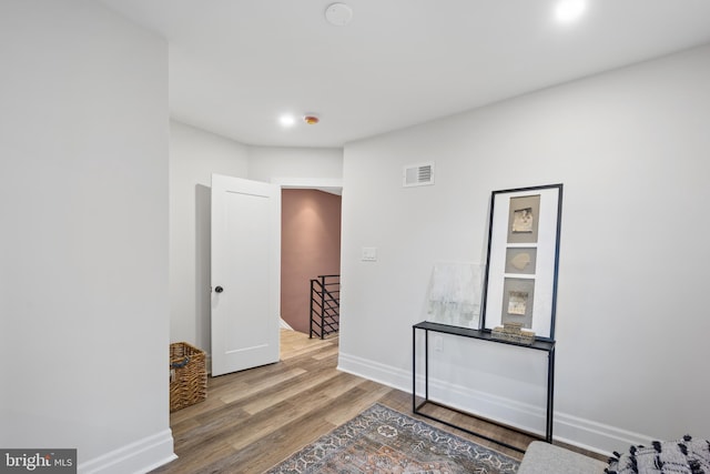 interior space featuring wood finished floors, visible vents, and baseboards