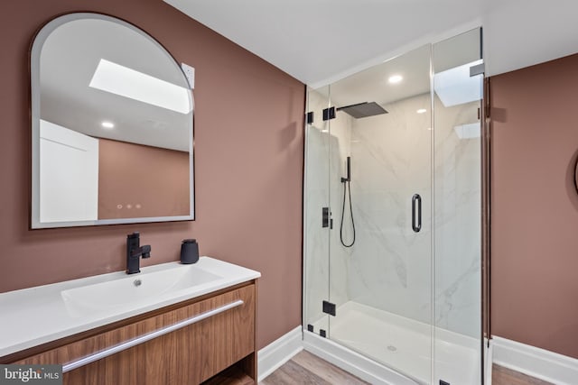 full bathroom with recessed lighting, a marble finish shower, baseboards, and vanity