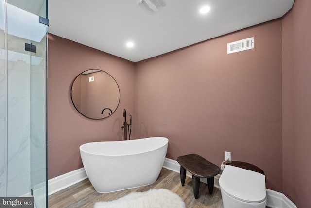 full bath with visible vents, baseboards, and wood finished floors