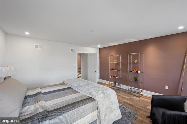 bedroom featuring recessed lighting, wood finished floors, visible vents, and baseboards