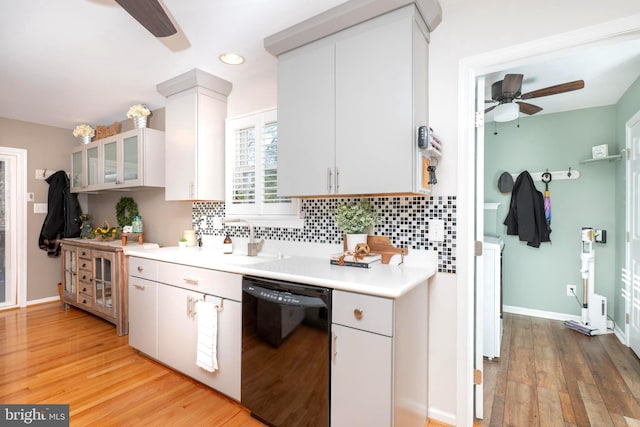 kitchen featuring light wood-style floors, tasteful backsplash, dishwasher, and light countertops